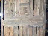 an old wooden door that is sitting in a garage