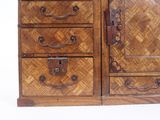 a wooden cabinet with drawers and a mirror on it