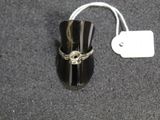 a ring with a skull on it sitting on a table