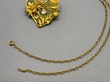 an image of a gold necklace with a heart shaped pendant on a chain