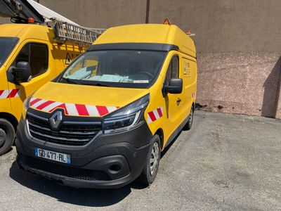 two yellow vans parked next to each other in a parking lot