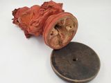 a piece of wood with a button on it and a piece of wood with a button on it