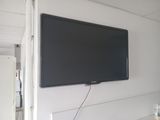 a flat screen tv mounted on the wall in a room