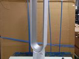 a white table with a fan on it in a room