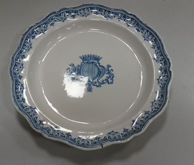 a blue and white plate with a crown on it