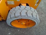 a large tire on the back of a construction vehicle