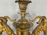 pair of antique brass candlesticks with lion heads on each of them