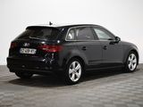 the rear end of a black audi car parked on a checkered floor