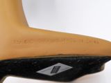 heel of a woman ' s shoe with a black sole and a brown heel