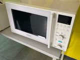 a microwave sitting on top of a table in a kitchen