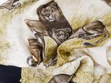 the scarf has a picture of lions and leopards on it