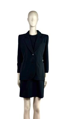 an image of a mannequin wearing a black suit and skirt