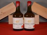 two bottles of wine sitting next to each other on a table
