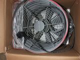 a box with a fan inside of it on the floor
