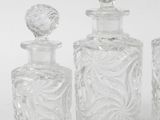 three clear glass bottles sitting next to each other on a white surface