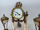 a clock that is sitting on top of a marble stand