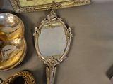 a table with a mirror, silverware, and other items on it