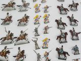 a lot of toy figurines of people riding horses and horses