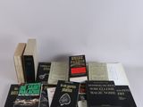 several books are stacked on a table with a white background