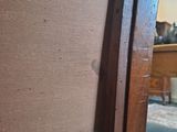 a close up of a chair with a wooden frame