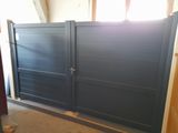 a picture of a garage with a blue gate