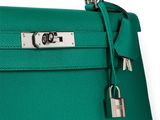 a close up of a green purse with a lock on it