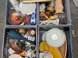a bin full of dishes and dishes sitting on the floor
