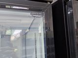 a glass door that is open to show the inside of a refrigerator