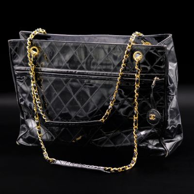 a close up of a black purse with a chain around it