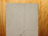 concrete block sitting on top of a wooden table in front of a picture