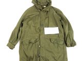 a green parka with a white tag on the chest