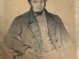 portrait of a man in a coat and bow tie holding a pair of scissors