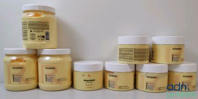 many jars of yellow paint sitting on a table