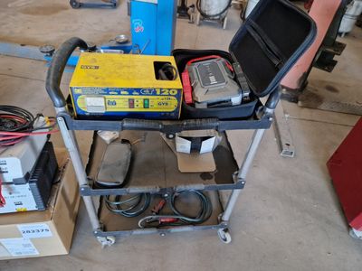 a small cart with tools on it in a garage