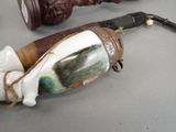 a pipe with a handle and a pipe holder on a table