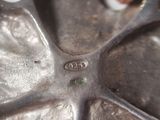 a close up of a metal object with a person in the background