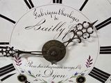 a gold clock with roman numerals on the face of it