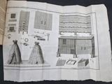 an open book with drawings on it on a table