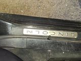 a close up of a car door handle with a name plate on it
