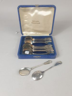 an assortment of silverware including spoons and spoons in a blue case