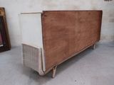 an old wooden cabinet with a white top and a brown top