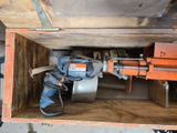 a drill in a wooden box with a hammer in it