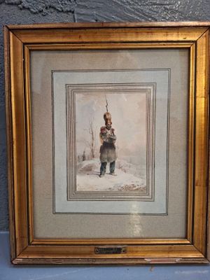 photo encadrée représentant un homme, coiffé d'un chapeau et vêtu d'un manteau, debout dans la neige