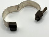 an image of a silver bracelet with a black clasp on a white surface