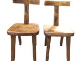 these are two wooden chairs sitting next to each other on a white surface