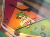 a close up of a pinball machine with a cartoon on it