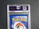 the pokemon card is in a clear plastic holder on a table