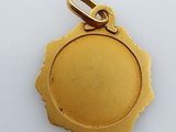 an image of a gold plated pendant with a flower design on it