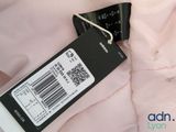 a label on the back of a pink shirt