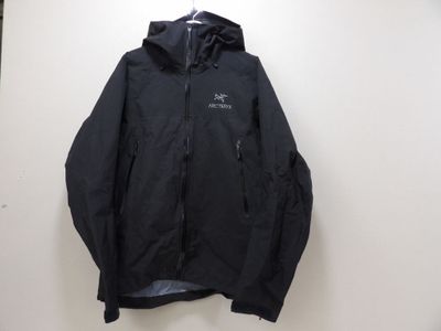 the back of a black jacket hanging on a wall